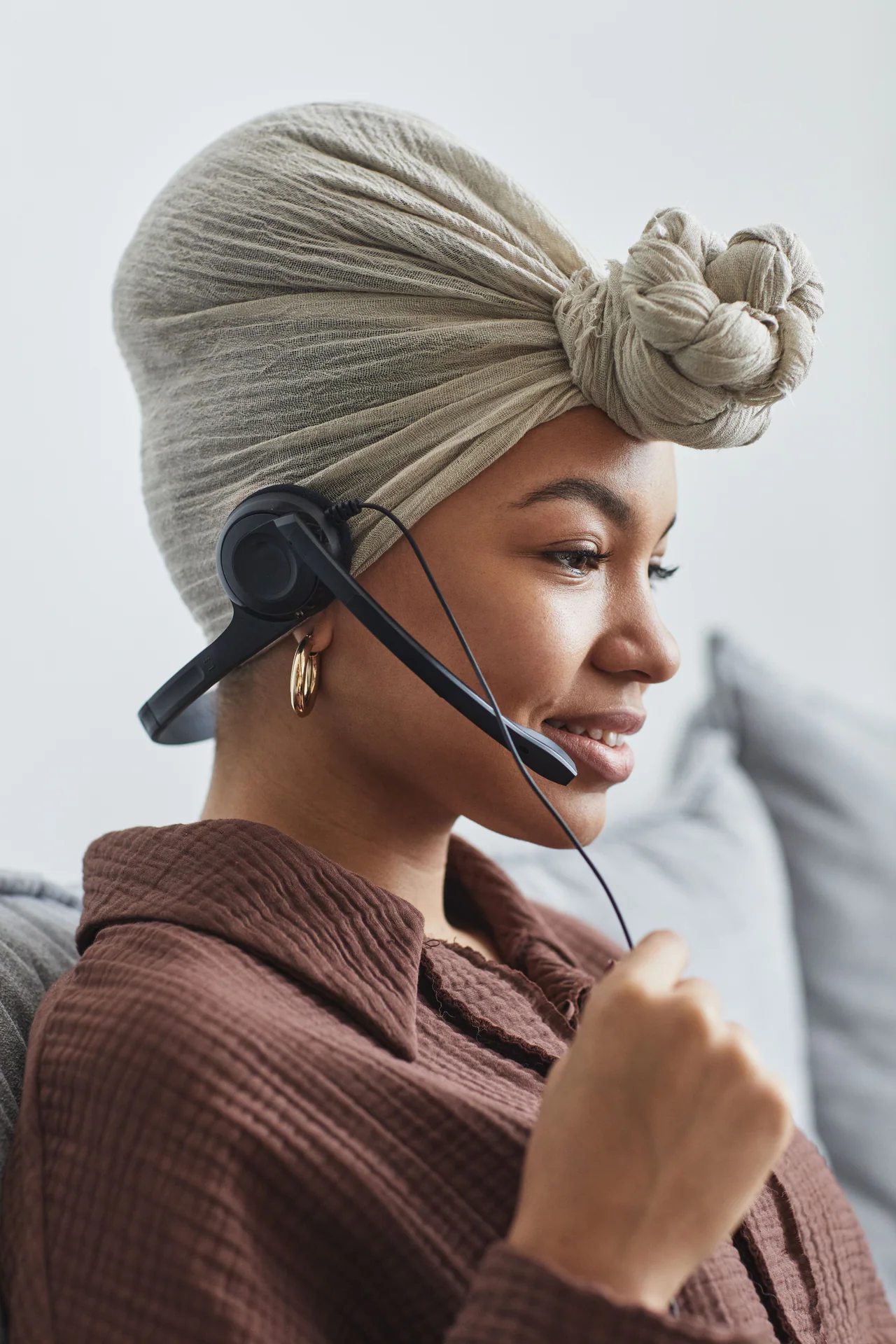 Black customer support agent wearing a headset in profile