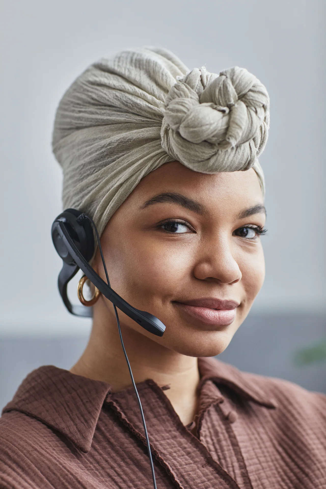 Smiling Black customer support specialist wearing a headset