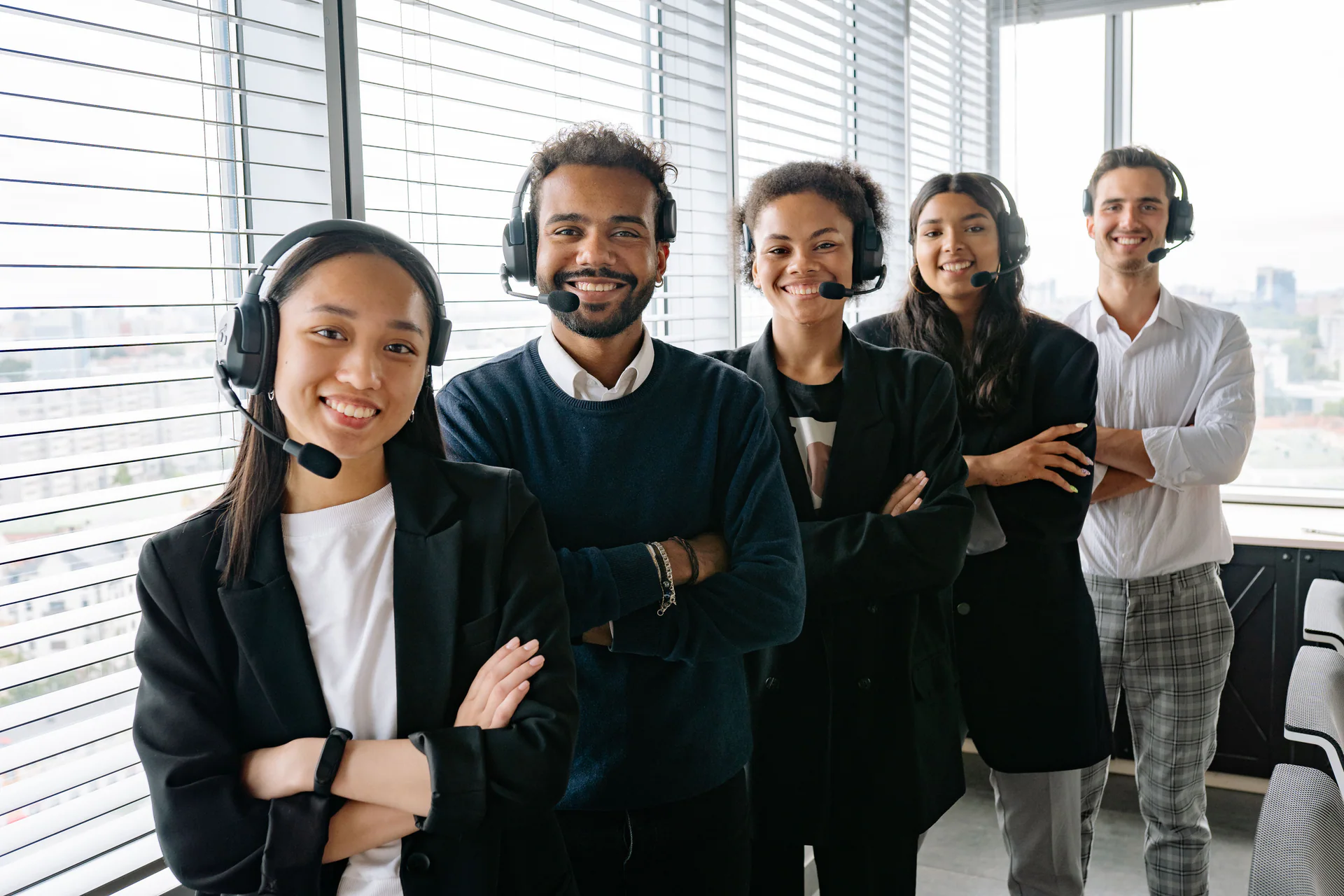 Diverse customer support team wearing headsets in a bright office